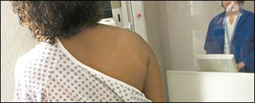 Photo: A woman receiving a mammogram
