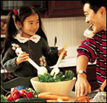Photo: Father and daughter preparing a salad