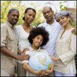 Photo: A group of people gathered around a boy holding a globe