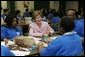 Laura Bush talks with students Wednesday, Nov. 30, 2005 during a visit to the Church of the Epiphany in Washington, as part of her Helping America's Youth initiative, where the students, part of the Youth Service Learning Project, were preparing sandwiches to feed the homeless. White House photo by Shealah Craighead