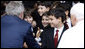 President George W. Bush shakes hands with members of The Pontifical Sistine Choir following their performance Friday, June 13, 2008, in the Lourdes Grotto at the Vatican. White House photo by Eric Draper