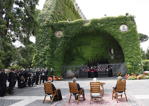 President George W. Bush and Mrs. Laura Bush join Pope Benedict XVI and Cardinal Tarcisio Bertone, Secretary of State, Vatican, as they watch a performance by The Pontifical Sistine Choir Friday, June 13, 2008, in the Lourdes Grotto at the Vatican. White House photo by Eric Draper