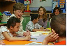 Mrs. Laura Bush helps Balkes Nafe put together a puzzle during a visit with young patients in the Children's Playroom at the King Hussein Cancer Center Thursday, Oct. 25, 2007, in Amman, Jordan. Also pictured are Her Royal Highness Princess Ghida Talal, left, and Her Royal Highness Princess Dina Mired bin Ra'ad. White House photo by Shealah Craighead