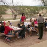 A Park Ranger welcomes a visiting school group.