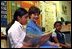 Laura Bush listens as a student at Caesar Chavez Elementary School reads during a "Ready to Read Ready to Learn" visit to the school in Hyattsville, Maryland, Feb., 26, 2001.