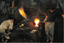 Workers casting hot metal