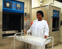 Keisha uses an autoclave (an industrial steam cleaner) to sterilize laboratory glassware.