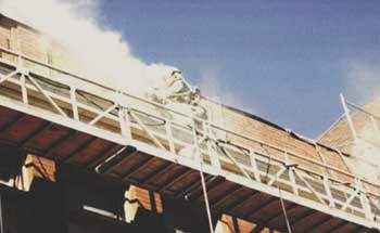 Worker doing uncontrolled mortar removal generating hazardous exposure to airborne dust.