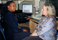 Carmen Brewer reviews research involving tune deafness or dysmelodia with Howard University student Jennifer Jones.