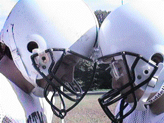 Football players at Walt Whitman High School in Bethesda, Maryland standing with their helmets touching.