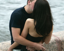 couple embracing against wall