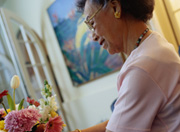Photo of elderly woman setting flowers