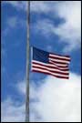 A United States flag flies at half mast