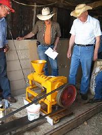 Men with oilseed crusher.