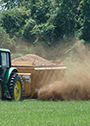 Farm equipment spreading manure