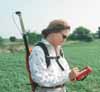 Woman in field operating GIS