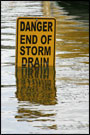 Flood waters rise to obscure a sign