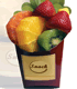 Image of fresh fruit in a paper container designed for fast food french fries