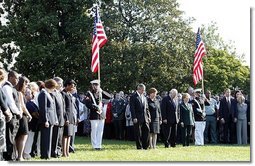 Honoring the memory of those who died during terrorist attacks on this day two years ago, President George W. Bush, Laura Bush, Vice President Dick Cheney and Lynne Cheney stand with White House staff for a moment of silence on the South Lawn 8:46 a.m., Thursday, Sept. 11, 2003.  White House photo by David Bohrer