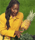 African American woman holding a pineapple.