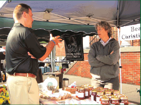 Commissioner Farmer chats with Carol Cassedy at the Heart of St. Matthews Farmers Market.