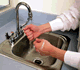 A Person Washes Their Hands in a Sink