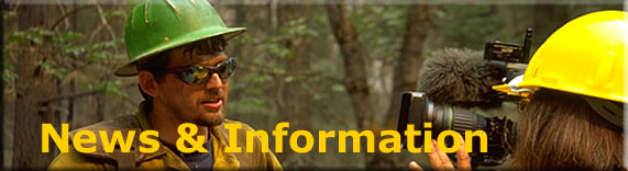 [Banner]  USDA Forest Service, Fire & Aviation News & Information.  Photo of a firefighter giving a briefing to a news reporter.