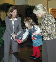 Young girl pulling winning ticket for drawing