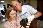 Earth Team volunteers Angela Butler (left) and Wallace Westervelt check pH levels of a water sample (Tulsa World photo by Mat Barnard)