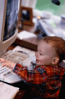 Photo of toddler playing at the computer