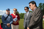 district conservationist Len Reno (left) and Pilgrim RC&D Coordinator Irene Winkler (center) discuss cranberry farm planning with members of the delegation