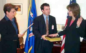 Chief Operating Officer Leonora L. Guarraia swears in Commisioner Leslie E. Silverman, with her husband, Jon Bernstein