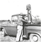 Joe D. Nichols stands next to a circa 60's truck with a hydraulic soil probe (NRCS photo -- click to enlarge)