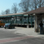 Cars parked in front of train station.