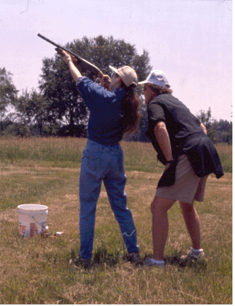 Instructor watching woman shoot