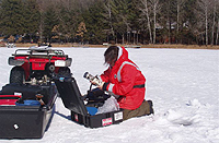  [Photo: USGS scientist collects water-quality samples in the snow.] 