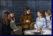 photo of female science teacher meeting with female students