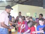 Ron Harris, NRCS district conservationist, teaches the students how to assess soil characteristics by touch