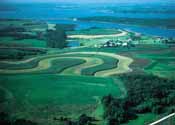 NRCS' Conservation Security Program rewards producers who meet the highest standards of conservation on their operations. Above, contour stripcropping, a multi-purpose practice used by many top-performing CSP participants, prevents soil erosion and keeps sediment and farm chemicals out of water in a central Iowa watershed. NRCS image.