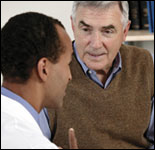 Photo: A man consulting a healthcare professional.