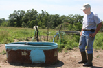 Bedford farmer Paul Ackley checks cattle watering tanks that are part of a new rotational grazing system NRCS designed for his farm. Ackley says he likes rotational grazing because the system allows him to raise the same number of cattle with one-third less land