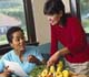 Two women discussing food and reviewing materials.