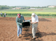 applying compost to research plots