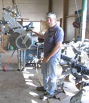 Bob Sinnard with a strip-till unit that he has modified and mounted on a new tool bar  (NRCS photo)