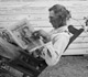 Farmer in rocking chair reading Progressive Farmer magazine.