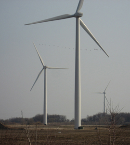row of three wind turbines