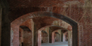 The arches at Fort Massachusetts are made of red and tan bricks.