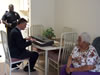 Congressman Rob Andrews visits with a resident of the Chesilhurst House to discuss the federal funding received by residents to have air conditioning units installed in their facility.