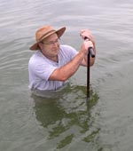 NRCS Soil Scientist David Harper is using a soil auger to examine soils in the York River