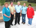 Celebrating the completion of a native prairie landscape restoration project on the grounds of the Sherburne County History Center were, from left, Sherburne County Commissioner Rachel Leonard, History Center Director Kurt Kragness and Sherburne County Soil and Water Conservation District vice-chairman Lee Schlosser, Gina Hugo and Chair Deb Seeley. A $4,300 donation from the Mid-Minnesota Mississippi River Resource Conservation and Development Council was a highlight of the gathering. (Photo by David Hannula, Sherburne County Citizen..)